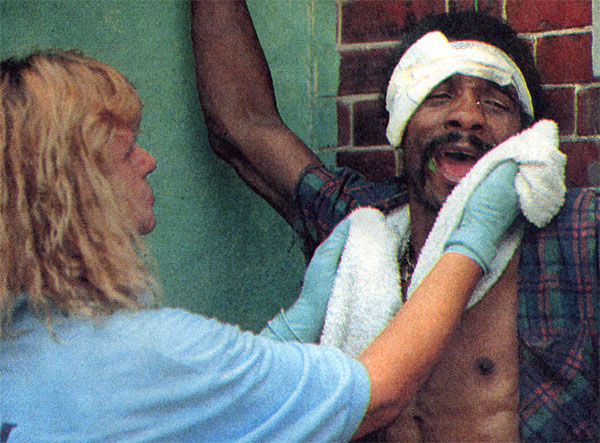 EMT Pat Kessler tries to calm boarder Ace Jackson after the fire at 1442 Rose Street