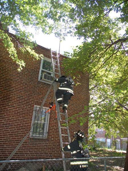 547 Pfeiffer Street fire, September 18, 2007 - Engine 9 firefighters taking water line to roof