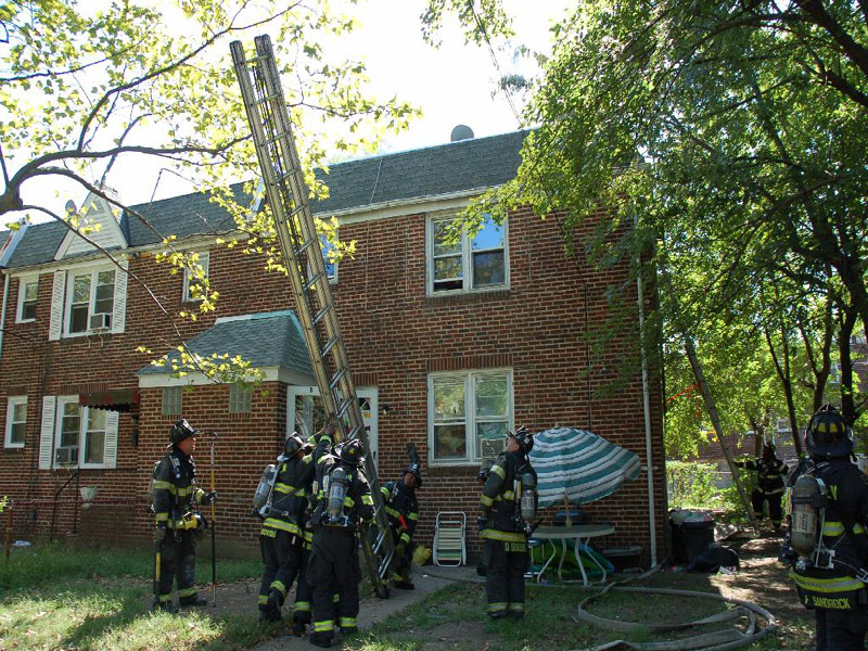 547 Pfeiffer Street fire — Ladder 3 putting up ladder to rescue man on roof