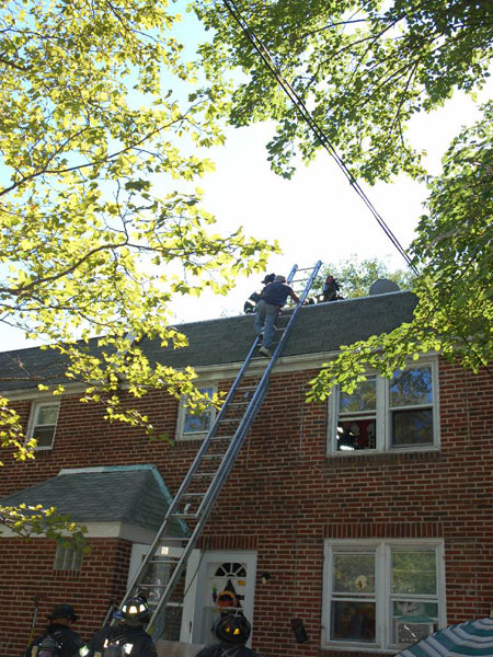 547 Pfeiffer Street fire — firefighters helping man onto ladder