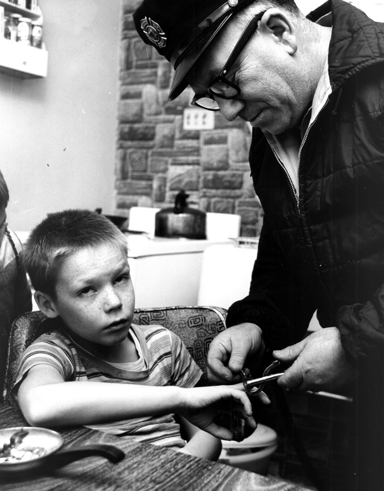 Fireman Ernest Tartaglia using a ring cutter in South Camden, circa 1965
