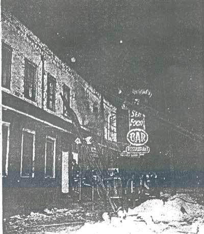 Firemen climb ladder at Ray's Tavern fire, 5th and Mickle Streets