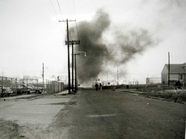 Remington Avenue intersection with North 36th Street, showing the entrance to the Campbell Soup warehouse and the crossing guard shack on fire, 1950s